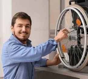 young man repairing wheelchair